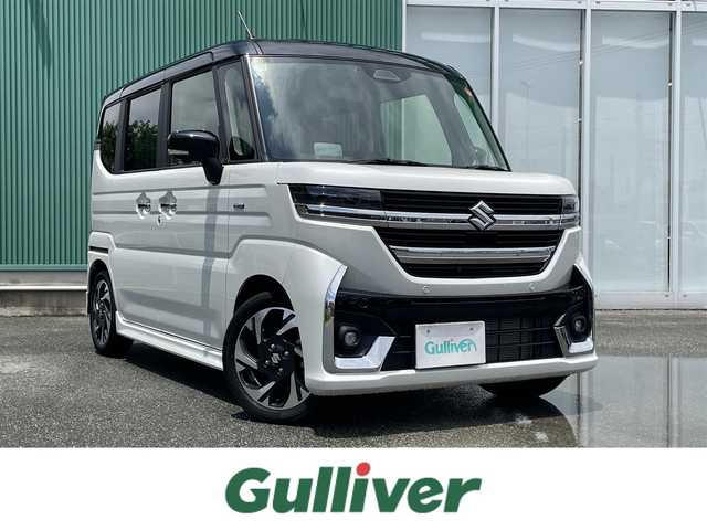 スズキ スペーシア カスタム HYBRID XS ターボ 福岡県 2024(令6)年 2.1万km ピュアホワイトパール/ブラック2トーン ワンオーナー/純正メモリナビゲーション/（フルセグTV/BT/Applecarplay）/全方位モニター/スリムサーキュレーター/ドライブレコーダー/デュアルセンサーブレーキサポートII/レーンキープアシスト/ブレーキホールド/LEDライト/フォグLEDライト/ビルトインETC/ハーフレザーシート/シートヒーター（D＋N）/本革ステアリング/ヒーター/2列目オットマン/両側パワースライドドア/エアバック（W＋サイド）/カーテンエアバック/純正15インチアルミホイール/アイドリングストップ/横滑り防止機能/フロアマット/荷室フロアマット/ドアバイザー/取扱説明書/新車保証書