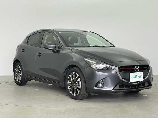 マツダ デミオ XD ツーリング 富山県 2015(平27)年 4.1万km メテオグレーマイカ 純正ナビ（AM/FM/BT/USB/DVD/ワンセグ）/衝突被害軽減システム/クルーズコントロール/横滑り防止装置/アイドリングストップ/純正アルミホイール/純正フロアマット/オートキセノンライト/ETC/革巻きステアリング/ステアリングスイッチ/パドルシフト/スマートキー