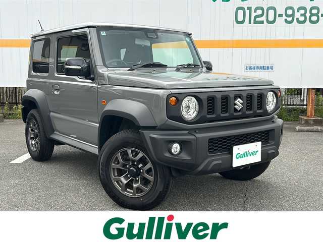 スズキ ジムニー シエラ JC 山口県 2024(令6)年 0.8万km ミディアムグレー ワンオーナー/衝突被害軽減ブレーキ/クルーズコントロール/LEDヘッドランプ/フォグランプ /オートライト/背面タイヤ/純正15インチアルミホイール/クリアランスソナー /電動格納ミラー/スペアキー/保証書/取扱説明書