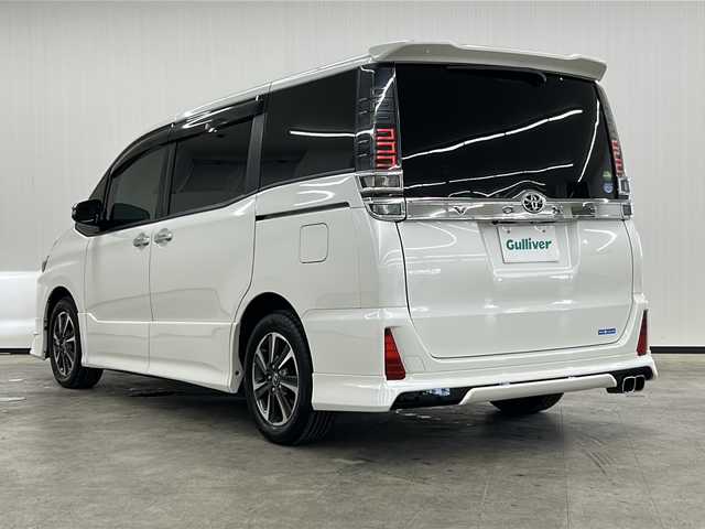 トヨタ ヴォクシー ZS 煌 長崎県 2018(平30)年 7.7万km ホワイトパールクリスタルシャイン 純正メモリナビ/（Bluetooth/CD/フルセグTV）/バックカメラ/ETC/純正前方ドライブレコーダー/横滑り防止装置/衝突被害軽減システム/レーンキープアシスト/両側パワスラ/純正16インチAW装着/モデリスタエアロ/純正フロアマット/ドアバイザー/フォグランプ/ウィンカーミラー/LEDヘッドライト/オートライト/オートマチックハイビーム/スマートキー/スペアキー1本/2列目サンシェード