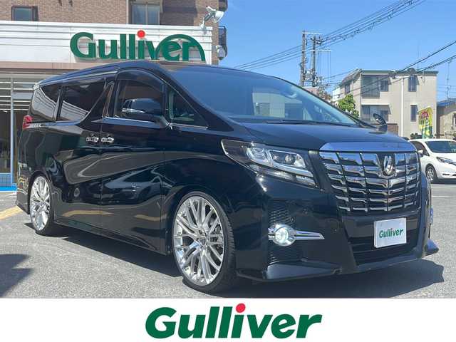トヨタ アルファード S 大阪府 2015(平27)年 4.3万km ブラック ワンオーナー/10インチALPINEナビ　/　【ワンセグTV/CD・DVD/Bluetooth/USB】/ALPINE12.8フリップダウンモニター/バックカメラ/レザーシート/パワーシート/オットマン/3列シート/ローダウン/社外テインダウンサス/両側パワースライドドア/クリアランスソナー/レーンキープアシスト/横滑り防止システム/衝突被害軽減システム/社外イルミネート/カールソンホイール/ドライブレコーダー/ETC