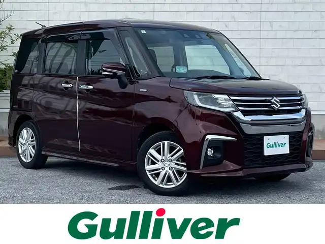 スズキ ソリオ HV MZ 滋賀県 2021(令3)年 2.5万km メロウディープレッドパール ガソリン/2WD/CVT/両側パワースライドドア/純正10インチナビ（CN-RZ10672A）/（FM/AM/CD/DVD/フルセグ/SD/Bluetooth）/バックカメラ・全周囲カメラ/運転席・助手席シートヒーター/ドライブレコーダー/クルーズコントロール/レーンキープアシスト/プリクラッシュブレーキアシスト/横滑り防止装置/コーナーセンサー/革巻きステアリング/ステアリングスイッチ/ヘッドアップディスプレイ/アイドリングストップ/電動格納ミラー/オートライト/オートエアコン/純正フロアマット/純正ドアバイザー/プッシュスタート/スマートキー/スペアキー