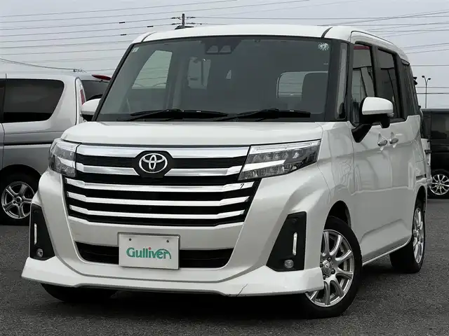 トヨタ ルーミー カスタムG－T 道央・札幌 2021(令3)年 1.4万km パールホワイトⅢ 寒冷地仕様/トヨタセーフティセンス/純正ディスプレイオーディオ/AM/FM/BT/フルセグ/衝突被害軽減ブレーキ/横滑り防止装置/レーダークルーズコントロール/レーンキープアシスト/クリアランスソナー/バックカメラ/サイドカメラ/フロントカメラ/全方位カメラ/アラウンドビューモニター/ビルトインETC/ドライブレコーダー/アイドリングストップ/ワイパーデアイサー/SPORTMODE/両側パワースライドドア/革巻きステアリング/ステアリングリモコン/電動パーキング/ブレーキホールド/プッシュスタート/スマートキー/LEDヘッドライト/オートライト/オートマチックハイビーム/フォグランプ/電動格納ミラー/ウィンカーミラー/純正フロアマット