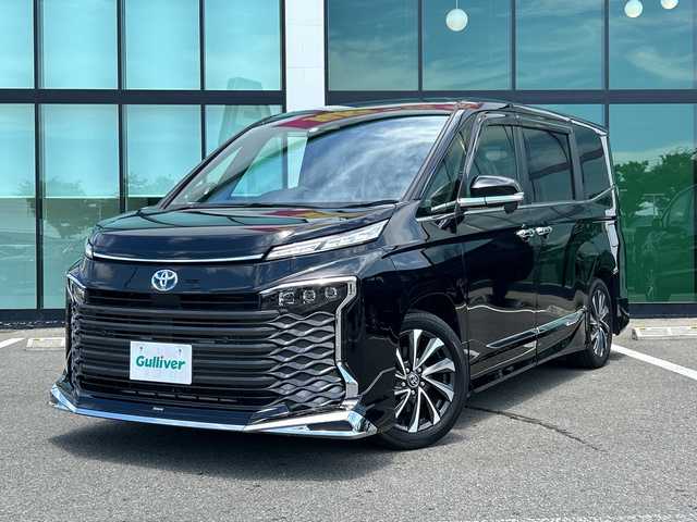 トヨタ ヴォクシー ハイブリッド S－Z 和歌山県 2022(令4)年 2.5万km アティチュードブラックマイカ 純正10.5インチナビ/フルセグTV/バックカメラ/デジタルインナーミラー/(BT/CD/DVD/HDMI）/プリクラッシュセーフティー/レーンディパーチャーアラート/ブラインドスポットモニター/ヘッドアップディスプレイ/クリアランスソナー/モデリスタエアロ/快適利便パッケージ/パワーバックドア/シートヒーター/ドラレコ/ビルトインETC2.0/AC100V充電/ステアリングヒーター/LEDヘッドライト/オートライト/オートマチックハイビーム