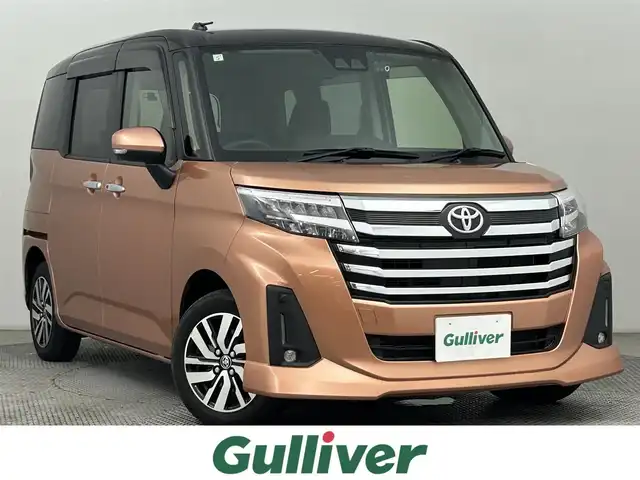 トヨタ ルーミー カスタムG 道央・札幌 2021(令3)年 1.8万km ブラックマイカメタリック/ブリリアントカッパークリスタルマイカ 2トーン ・４WD/・寒冷地仕様/・ディーラーオプション９インチSDナビ/・CD/DVD/BT/SD/フルセグTV/・バックカメラ/・ステアリングスイッチ/・ビルトインETC/・スマートアシスト/・プリクラッシュセーフティ/・レーンキープアシスト/・レーダークルーズコントロール/・アイドリングストップ/・電動パーキングブレーキ/・ブレーキホールド/・両側パワースライドドア/・D席＋N席ヒートヒーター/・２列目サンシェード/・シートバックテーブル/・オートマチックハイビーム/・オートライト/・LEDヘッドライト/・LEDフォグランプ/・LEDデイライト/・ドアミラーウィンカー/・オートリトラクタブルドアミラー/・ドアバイザー/・純正フロアマット/・プッシュスタート/・スマートキー/・純正１４インチAW（夏）