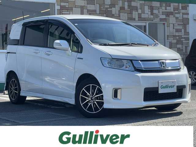 ホンダ フリード スパイク ハイブリット ジャストセレクション 徳島県 2014(平26)年 9.5万km ホワイトオーキッドパール 社外SDナビ　VXM-152VFi/　AM/FM/BT/SD/DISC/Music Rac/フルセグ/ドライブレコーダー/後席用モニター　VM-155EN/ビルトインETC/両側電動スライドドア/バックカメラ/クルーズコントロール/社外15インチアルミホイール　SPORT KRONE/ドアバイザー/純正フロアマット/オートライト/スマートキー/スペアキー/E CON/新車時保証書/新車時取扱説明書
