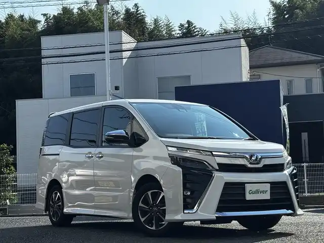 トヨタ ヴォクシー ZS 煌 熊本県 2018(平30)年 9.2万km ホワイトパールクリスタルシャイン ALPINE11インチナビ（EX11Z）/【フルセグTV/CD/DVD/Bluetooth/HDMI/ラジオ】/バックカメラ/12.8インチALPINEフリップダウンモニター/（PXH12X-R）/両側パワースライドドア/クルーズコントロール/プリクラッシュセーフティ/レーンキープアシスト/アイドリングストップ/純正16インチAW/ETC/オートライト/オートハイビーム/LEDヘッドライト/フォグランプ/横滑り防止機能/純正フロアマット/革巻きステアリング/ステアリングスイッチ/保証書/取扱説明書