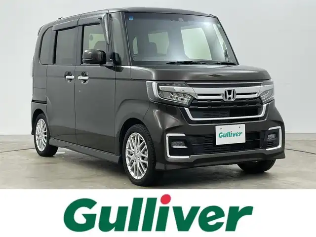 ホンダ Ｎ ＢＯＸ カスタム L ターボ 岡山県 2021(令3)年 2.7万km プレミアムグラマラスブロンズP 純正８インチナビ　(VXU-217NBi)/(CD/DVD/BT/USB/フルセグ)/レーダークルーズコントロール　/両側電動スライドドア　/ＬＥＤヘッドライト　/シートヒーター　前席/ビルトインＥＴＣ　/純正ドライブレコーダー　前後/バックカメラ　/コーナーセンサー　後/オートハイビーム　/LEDフォグランプ/禁煙車/アイドリングストップ/純正アルミホイール/パドルシフト/踏み間違い防止