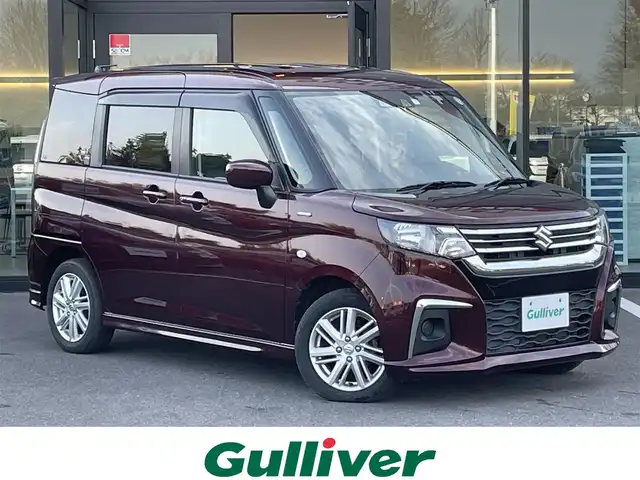 スズキ ソリオ HV MZ 栃木県 2021(令3)年 4万km メロウディープレッドパール スズキセーフティサポート/・デュアルカメラブレーキサポート/・誤発進抑制機能/・後退時ブレーキサポート/・車線逸脱警報機能/・車線逸脱抑制機能/・ふらつき警報機能/・標識認識機能/・ハイビームアシスト/・先行車発進お知らせ機能/・アダプティブクルーズコントロール/片側電動スライドドア/パーキングセンサー/D/N席シートヒーター/アイドリングストップ/オートライト/ヘッドライトレベライザー/スマートキー×２/プッシュスタート/USBポート（充電用）/純正15インチAW/横滑り防止システム/電動格納ミラー