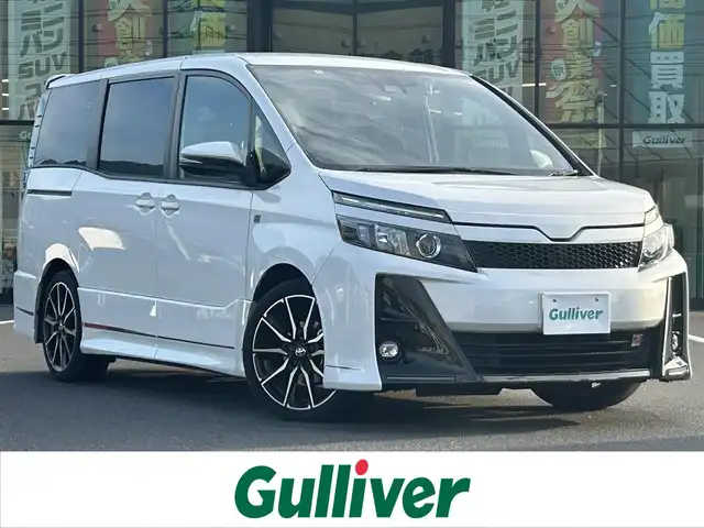 トヨタ ヴォクシー ZS GRスポーツ 奈良県 2020(令2)年 6.5万km ホワイトパールクリスタルシャイン 登録時走行距離64751km/純正10インチナビ/フルセグTV(AM.FM.CD.DVD.TV.BT)/純正フリップダウンモニター/両側パワースライドドア/バックカメラ/ETC/ドライブレコーダー/シートヒーター/クリアランスソナー/衝突軽減ブレーキ/横滑り防止装置/クルーズコントロール(追従走行なし)/車線逸脱警報（レーンキープアシスト）/オートライト/オートマチックハイビーム/アイドリングストップ/18インチ純正AW/純正フロアマット/ハーフレザーシート