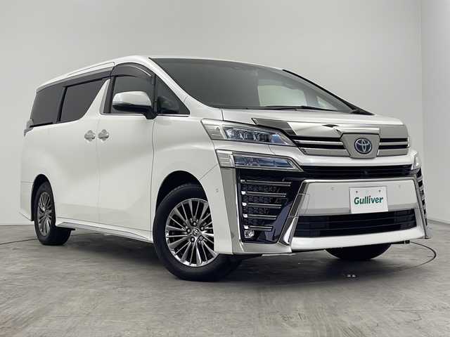 トヨタ ヴェルファイア ハイブリット エグゼクティブ ラウンジ Z 三重県 2021(令3)年 4.9万km ホワイトパールクリスタルシャイン 禁煙車/純正10.5インチナビ/・フルセグ・CD・DVD・Bluetooth・USB・AppleCarPlay・AndroidAuto/パノラミックビューモニター/JBLプレミアムサウンド/純正フリップダウンモニター/オットマン/CD/DVDデッキ/トヨタセーフティセンス/・アダプティブハイビームシステム/・プリクラッシュセーフティ/・レーントレーシングアシスト/・レーダークルーズコントロール/・ロードサインアシスト/デジタルインナーミラー/ブラインドスポットモニター/前席パワーシート（運転席メモリ付き）/シートヒーター/ベンチレーション/ステアリングヒーター/置くだけ充電/前後ドライブレコーダー/AC100V/スペアタイヤ