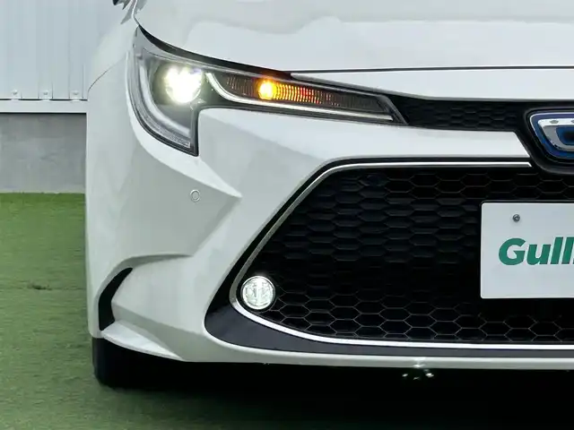 トヨタ カローラツーリング ハイブリッド ダブルバイビー 香川県 2020(令2)年 5.4万km ホワイトパールクリスタルシャイン 登録時走行距離：53410km/純正ナビ /フルセグ　/Bカメラ　/クルコン　/ETC　/ドラレコ /革巻きステアリング　/ステアリングリモコン　/純正AW　/純正フロアマット　/レーンキープアシスト　/BSM　/レベライザー/シートヒーター　/スペアキー/プッシュスタート