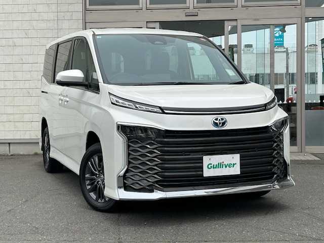トヨタ ヴォクシー ハイブリッド S－Z 青森県 2025(令7)年 0.1万km未満 ホワイトパールクリスタルシャイン ワンオーナー/Toyota Safety Sense/寒冷地仕様/ディスプレイオーディオ１０．５(フルセグ)/ＣＤ＋ＤＶＤデッキ/アドバンストパーク/パノラミックビューモニター＋ＰＫＳＢ/ＬＥＤヘッドランプ/両側電動スライドドア/スペアキー/ＥＴＣ2.0/AC100V/シートヒーター運転席/助手席/純正フロアマット/新車購入時保証書/取扱説明書