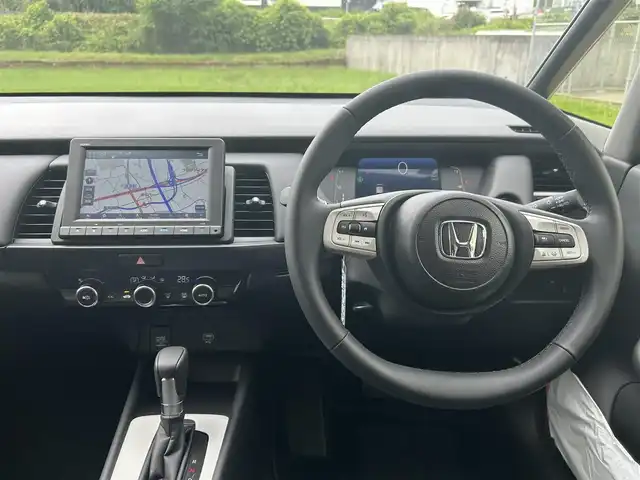 ホンダ フィット e:HEVホーム 長崎県 2023(令5)年 0.1万km プラチナホワイトパール ワンオーナー/純正HDDナビ/(CD/DVD/BT/フルセグ)/バックカメラ/衝突軽減ブレーキ/レーンアシスト/コーナーセンサー/レーダークルーズ/ハーフレザーシート/ETC/オートライト/電子パーキングブレーキ/電動格納ミラー