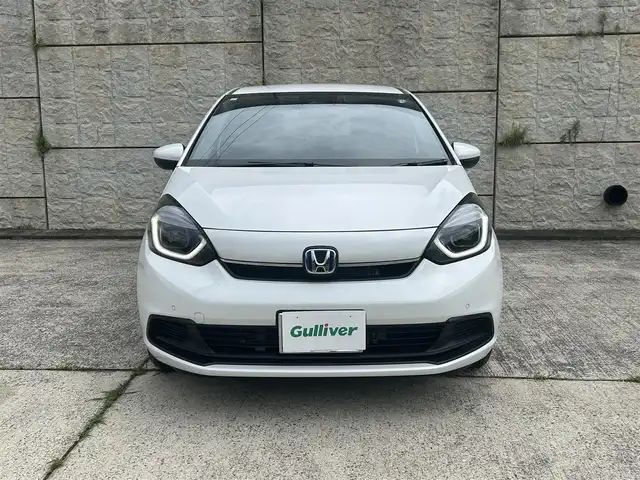 ホンダ フィット e:HEVホーム 長崎県 2023(令5)年 0.1万km プラチナホワイトパール ワンオーナー/純正HDDナビ/(CD/DVD/BT/フルセグ)/バックカメラ/衝突軽減ブレーキ/レーンアシスト/コーナーセンサー/レーダークルーズ/ハーフレザーシート/ETC/オートライト/電子パーキングブレーキ/電動格納ミラー