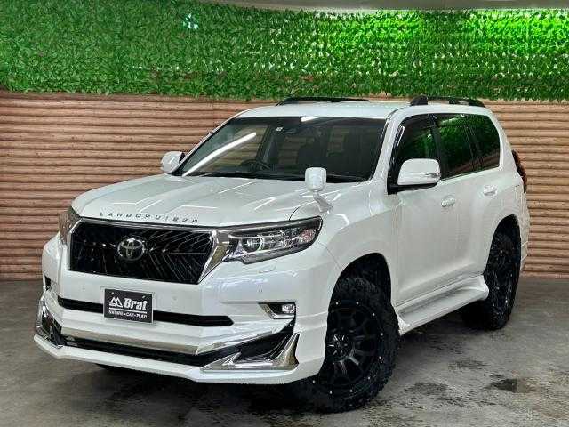 トヨタ ランドクルーザー プラド TX Lパッケージ 道北・旭川 2017(平29)年 2.5万km ホワイトパールクリスタルシャイン 【2405032058】/アルパイン9インチナビ（社外）/クルーズコントロール/前席シートヒーター/ベンチレーター/ETC/オートハイビーム/ヘッドライトウォッシャー/センターデフロック/コーナーセンサー/純正フロアマット/純正ドアバイザー/7人乗り/20AW ナイトロパワー  H6スラッグ（社外）/レーダー　レネゲードR/T＋（社外）/ボンネットエンブレム/社外パーツ取り付けあり。