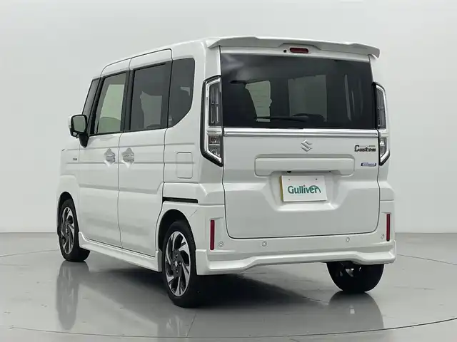 スズキ スペーシア カスタム HYBRID XS ターボ 熊本県 2024(令6)年 1.2万km ピュアホワイトP 禁煙車　/純正ナビ（ＡｐｐｌＣａｒＰｌａｙ・ＡｎｄｒｏｉｄＡｕｔｏ・ＢＴ・フルセグ）/全周囲カメラ　/両側パワースライドドア　/前後クリアランスソナー　/前席シートヒーター　/ステアリングヒーター/スズキセーフティサポート/・デュアルセンサーブレーキサポート/・誤発進制御機能/・後方誤発進抑制/・車線逸脱警報/・車線逸脱抑制機能/・ふらつき警報機能/・発進お知らせ機能/・標識認識機能/・アダブティブクルーズコントロール/横滑り防止/アイドリングストップ/ヘッドアップディスプレイ/純正フロアマット/純正１５インチAW/オートライト/LEDヘッドライト/フォグライト/スマートキー/プッシュスタート/スペアキー1本/保証書/取扱説明書