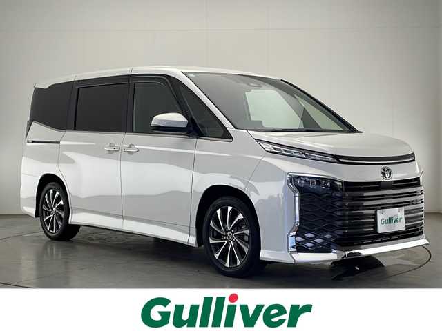 トヨタ ヴォクシー S－Z 宮崎県 2024(令6)年 2.1万km ホワイトパールクリスタルシャイン 禁煙車/トヨタセーフティセンス/純正10.5型ディスプレイオーディオナビTV/（T-CONNECT/Bluetooth/CD/DVD/フルセグTV)/純正14.1型リアフリップダウンモニター/（V14T-R72R）/純正ビルトイン2.0ETC/純正LEDオートライト/純正18インチアルミ/純正フロアマット/両側電動スライドドア/パワーバックドア/プリクラッシュセーフティ/アダプティブクルーズコントロール/レーンディパーチャーアラート/オートマチックハイビーム/電子パーキング/オートホールド/ハーフレザーシート/シートヒーター/Wオートエアコン（ナノイーX）/本革巻ハンドル/ウインカードアミラー/スマートキー/プッシュエンジンスタート/新車時保証書/取扱い説明書