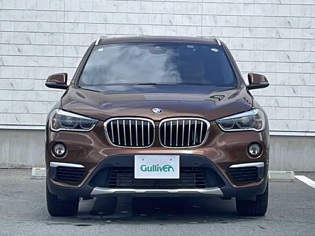 ＢＭＷ Ｘ１ xDrive 20i 山形県 2015(平27)年 5.6万km 茶 禁煙車/４WD/純正ナビ（CD.DVD.Bluetooth.AUX）/バックカメラ/アイドリングストップ/ヒートシーター/サンルーフ/スマートキー/横滑り防止装置/コーナーセンサー/ABS/エアバッグWサイド