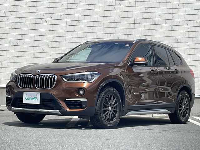 ＢＭＷ Ｘ１ xDrive 20i 山形県 2015(平27)年 5.6万km 茶 禁煙車/４WD/純正ナビ（CD.DVD.Bluetooth.AUX）/バックカメラ/アイドリングストップ/ヒートシーター/サンルーフ/スマートキー/横滑り防止装置/コーナーセンサー/ABS/エアバッグWサイド