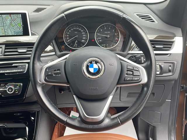 ＢＭＷ Ｘ１ xDrive 20i 山形県 2015(平27)年 5.6万km 茶 禁煙車/４WD/純正ナビ（CD.DVD.Bluetooth.AUX）/バックカメラ/アイドリングストップ/ヒートシーター/サンルーフ/スマートキー/横滑り防止装置/コーナーセンサー/ABS/エアバッグWサイド