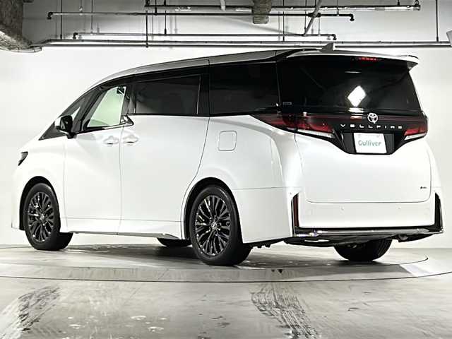 トヨタ ヴェルファイア ハイブリット Z プレミア 広島県 2024(令6)年 0.9万km プラチナホワイトパールマイカ 禁煙/左右独立ムーンルーフ/トヨタチームメイト/・アドバンストパーク/・パーキングサポートブレーキ/・アドバンストドライブ/・緊急時操舵支援/・フロントクロストラフィックアラート/・レーンチェンジアシスト/・ドライバーモニターカメラ/セーフティセンス/・プリクラッシュセーフティ/・レーントレーシングアシスト/・レーダークルーズコントロール/・アダプティブハイビーム/・ロードサインアシスト/・ドライバー異常時対応/・プロアクティブドライビングアシスト/・発進遅れ告知機能/BSM/パーキングサポートブレーキ/デジタルインナーミラー/純正14インチディスプレイ/ナビ/・地デジTV/・ETC2.0/パノラミックビューモニター/フリップダウンモニター（V12T-R72C）/HUD/両側パワースライドドア/パワーバックドア/シートヒーター/ベンチレーション/パワーシート/メモリーシート/ステアリングヒーター/ドライブレコーダー（TZ-DR210）/おくだけ充電/フロアマット/ドアバイザー/AC100V1500W/スペアタイヤ