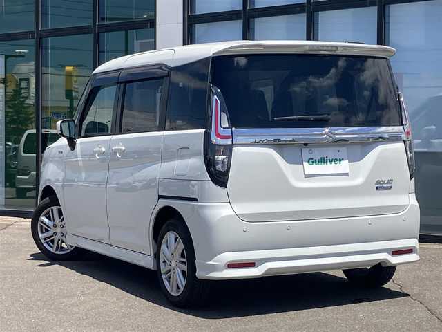 スズキ ソリオ HV MZ 道南・函館 2023(令5)年 0.7万km ピュアホワイトP 純正ナビ/フルセグＴＶ/衝突軽減ブレーキ/夏冬タイヤ/エンジンスターター/バックカメラ/ドライブレコーダー/シートヒーター/両側パワースライドドア/ＨＵＤ/クルーズコントロール/コーナーセンサー
