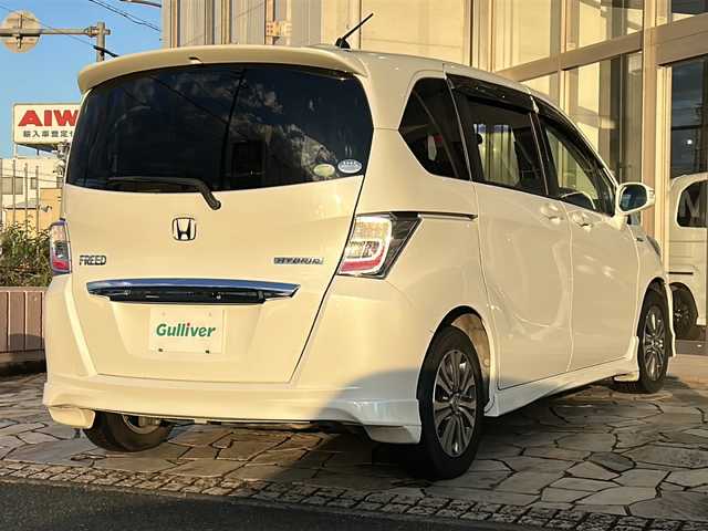 ホンダ フリード ハイブリット 静岡県 2012(平24)年 10.3万km プレミアムホワイトパール 純正ナビ（CD DVD Bluetooth フルセグTV AM FM）/クルーズコントロール/両側パワースライドドア/3列シート/ハーフレザーシート/キャプテンシート/革ステアリング/ステアリングリモコン/ETC/純正フロアマット/純正アルミホイール/横滑り防止装置/ABS/キノセンヘッドライト/オートライト