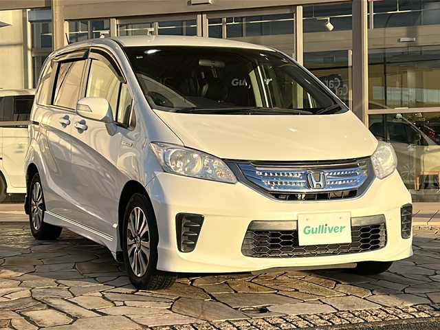 ホンダ フリード ハイブリット 静岡県 2012(平24)年 10.3万km プレミアムホワイトパール 純正ナビ（CD DVD Bluetooth フルセグTV AM FM）/クルーズコントロール/両側パワースライドドア/3列シート/ハーフレザーシート/キャプテンシート/革ステアリング/ステアリングリモコン/ETC/純正フロアマット/純正アルミホイール/横滑り防止装置/ABS/キノセンヘッドライト/オートライト