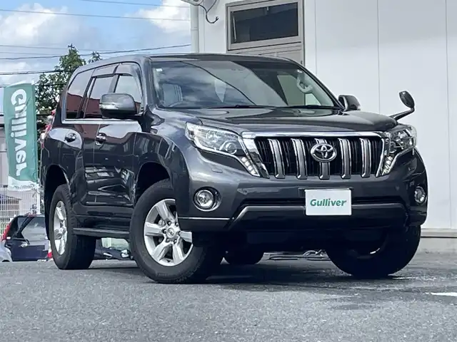 トヨタ ランドクルーザー プラド TX Lパッケージ 宮城県 2015(平27)年 12.2万km グレーメタリック 純正ナビ/　CD/DVD/　FM/AM/　フルセグテレビ/　Bluetooth/エンジンスターター　/４ＷＤ　/７人乗り３列シート/自動収納サードシート/ターボ　/純正アルミホイール１７インチ/ヒーターアイドルアップ/フロントワイパーデアイサー/ETC/センターデフロック/パワーシート/シートヒーター/クルーズコントロール/ダウンヒルアシストコントロール/横滑り防止