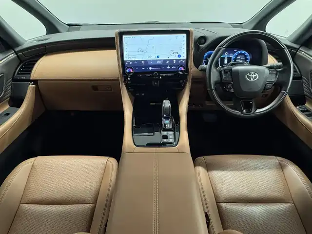 トヨタ ヴェルファイア ハイブリット Z プレミア 三重県 2024(令6)年 0.7万km ブラック ハイブリッド/FF/MTモード付フロアCVT/14型ナビ/（FM/AM/TV/Bluetooth/USB/iPod/Miracast/CarPlay/AndroidAuto）/13.2型 有機EL後席モニター V13T-R72F/パノラミックビューモニター（床下透過機能付）/モデリスタエアロ（F/S/R下）、シグネチャーイルミブレード/両側パワースライドドア/ドラレコ前後/ETC2.0/Toyota Safety Sense/●PCS、LTA、レーダークルコン、アダプティブハイビーム、RSA、PDA、緊急操舵支援＋前後クロストラフィックアラート*/●パーキングサポートブレーキ/・BSM/LCA/安心降車アシスト/・Advanced Drive/アドバンスト・パーク　など/装備/・【OP】デジタルインナーミラー/・【OP】ユニバーサルステップ（両側）/・左右独立ムーンルーフ/・プレミアムナッパ本革シート（茶）/・シートヒーター＆ベンチレーション（D/N/2nd）/・ステアリングヒーター/・パワーシート（Dメモリー付8way/N4way/2ndリクライニング＆オットマン）/・パワーバックドア/・HUD/・100Vコンセント（1500W）/・タッチトレーサーオペレーション/・3眼LEDヘッドランプ/・おくだけ充電/・19inAW/・保/・スマートキーx2/など