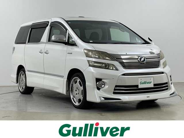 トヨタ ヴェルファイア ハイブリット ZR 道央・札幌 2012(平24)年 4.7万km ホワイトパールクリスタルシャイン ・４WD/・モデリスタエアロ（フロント.リア）/・ムーンルーフ/・純正HDDディーラーOPナビ/・DVD.CD.SD.Bluetooth/・フルセグTV/バックカメラ/・両側パワースライドドア/・パワーバックドア /・助手席・二列目オットマンシート/・運転席・助手席パワーシート/・HIDライト/オートライト/・クルーズコントロール/・ウッドコンビハンドル/・クリアランスソナー/・ドライブレコーダー前後/・ETC/AFS/・メッキパーツ多数
