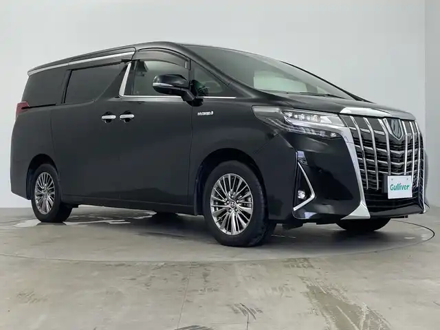 トヨタ アルファードハイブリット エグゼクティブ ラウンジ 鹿児島県 2019(令1)年 3.5万km ブラック ・両側パワースライドドア/・パワーバックドア/・１５００Ｗコンセント/・ＪＢＬプレミアムサウンドシステム/（ＣＤ/ＤＶＤ/ＢＤ/フルセグ）/・純正フリップダウンモニター/・１２．１インチリアエンターテイメントシステム/・クリアランスソナー/・デジタルインナーミラー////トヨタセーフティセンス////・レーダークルーズコントロール/・プリクラッシュセーフティ/・ブラインドスポットモニター/・レーントレーシングアシスト/・パーキングサポートブレーキ/・リアクロストラフィックアラート/・ロードサインアシスト/・先行車発進通知/・黒革シート/・Ｄ席メモリーシート/・Ｎ席オットマン/・前席パワーシート/エアシート/シートヒーター/・２列目エグゼクティブラウンジシート/パワーシート/エアシート/シートヒーター/オットマン/・純正１７インチアルミ/・ブレーキホールド/・３眼ＬＥＤヘッドライト/オートライト/・オートワイパー/・前後ドライブレコーダー/・スペアキー×１
