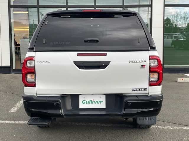 トヨタ ハイラックス Z GRスポーツ 道東・釧路十勝 2024(令6)年 1.1万km プラチナホワイトパールマイカ ・寒冷地仕様/・4WD/・純正ディスプレイオーディオ/(ナビ・FM・AM・BT・Miracast)/・全方位カメラ/・トヨタセーフティセンス/・プリクラッシュセーフティ/・レーンキープアシスト/・レーダークルーズコントロール/・ダウンヒルアシストコントロール/・横滑り防止/・GR専用シート/・純正マッドフラップ/・TRDフロアマット/・センターデフロック/・アイドリングストップ/・LEDヘッドライト/・オートライト/・社外キャノピー/・パドルシフト/・スマートキー/・プッシュスタート/・夏用タイヤ【2023年　4ミリ】　積込