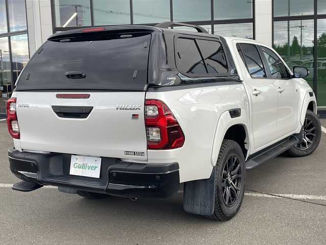 トヨタ ハイラックス Z GRスポーツ 道東・釧路十勝 2024(令6)年 1.1万km プラチナホワイトパールマイカ ・寒冷地仕様/・4WD/・純正ディスプレイオーディオ/(ナビ・FM・AM・BT・Miracast)/・全方位カメラ/・トヨタセーフティセンス/・プリクラッシュセーフティ/・レーンキープアシスト/・レーダークルーズコントロール/・ダウンヒルアシストコントロール/・横滑り防止/・GR専用シート/・純正マッドフラップ/・TRDフロアマット/・センターデフロック/・アイドリングストップ/・LEDヘッドライト/・オートライト/・社外キャノピー/・パドルシフト/・スマートキー/・プッシュスタート/・夏用タイヤ【2023年　4ミリ】　積込