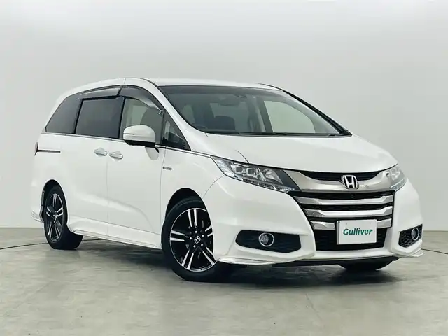 ホンダ オデッセイ ハイブリッド 福島県 2017(平29)年 7.4万km ホワイトオーキッドパール ホンダセンシング　/・車線逸脱警報/・CMBS/・BSM/・レーダークルーズコントロール/・レーンアシスト/・車線逸脱警報/全方位カメラ　/純正ナビゲーション　/ＥＴＣ　/両側パワースライドドア　/ハーフレザーシート　/・パワーシート　/ドライブレコーダー　/プッシュスタート　/・スマートキー　/・スペアキー　/オートライト　/・LＥＤライト/オットマン/革巻きステアリング/・ステアリングスイッチ/・チルトステアリング/保証書/・取扱説明書/