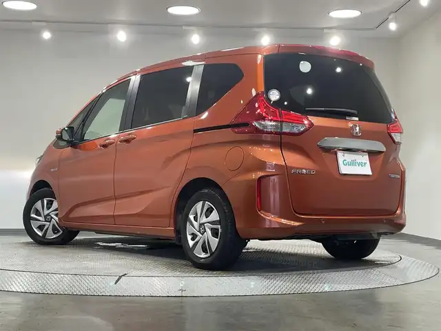 ホンダ フリード ハイブリット G ホンダセンシング 愛知県 2020(令2)年 4.7万km プレミアムクリスタルオレンジM KENWOOD7インチナビ/（Bluetooth/AM/FM/フルセグTV）/衝突軽減ブレーキ/両側電動スライドドア/レーダークルーズコントロール/シートヒーター/LEDヘッドライト/ETC/バックカメラ/コーナーセンサー/レーンキープアシスト/プッシュスタートボタン/スマートキー/純正15インチAW/社外ホイール付きスタッドレス