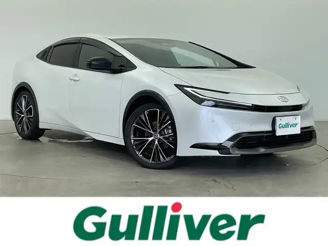 トヨタ プリウス Z 富山県 2024(令6)年 1.6万km プラチナホワイトパールマイカ 12.3インチDA（AM/FM/BT/USB）/・ナビ機能有/・AppleCarplay/・AndroidAuto/フルセグTV（キャンセラー付）/全方位カメラ/プリクラッシュセーフティシステム/レーンキープアシスト/レーダークルーズコントロール/クリアランスソナー/パーキングアシスト/BSM/PDA/RCTA/RCD/PKSB/RSA/LCA/FCTA/安心降車アシスト/周辺車両接近時サポート/後方車両接近告知/ドライブレコーダー/レザーシート/D席メモリ付パワーシート/前席シートヒーター/前席エアシート/ハンドルヒーター/ビルトインETC2.0/ワイヤレス充電/100V電源/横滑り防止装置/コーナーセンサー/パーキングアシスト/電動リアゲート/電格ウィンカーミラー/電動パーキングブレーキ/オートブレーキホールド/LEDヘッドライト/フォグランプ/プッシュスタート/スマートキー/保証書/取扱説明書