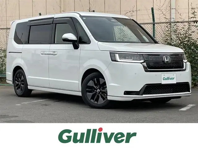 ホンダ ステップワゴン スパーダ 東京都 2025(令7)年 0.1万km パール 純正9型ホンダコネクトナビ＆フルセグ　/・AppleCarPlay＆AndroidAuto/・BluetoothAudio/両側パワースライドドア　/パワーバックドア　/ブラインドスポットモニター　/ホンダセンシング/（安全運転支援システム）/・衝突軽減ブレーキ/・後方誤発進抑制機能/・歩行者事故低減ステアリング/・渋滞追従機能付クルーズコントロール/・車線維持支援システム/・先行者発進お知らせ機能/・誤発進抑制/・近距離衝突軽減ブレーキ/・標識認識機能/撥水ファブリックコンビシート /・前席シートヒーター/・キャプテンシート /・オットマンシート/ＬＥＤヘッドライト /シートバックテーブル/ビルトインETC/プッシュエンジンスタート/スマートキー/保証書＆取説