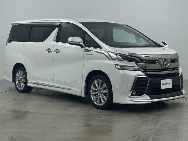 トヨタ ヴェルファイア ハイブリット 道央・札幌 2015(平27)年 5.1万km ホワイトパールクリスタルシャイン ・4WD/・JBLサウンドナビ/（CD DVD SD BT USB フルセグ）/・モデリスタエアロ（F S R）/・モデリスタマフラーカッター/・トヨタセーフティセンス/・純正フリップダウン/・両側パワースライドドア/・クルーズコントロール/・クリアランスソナー/・社外ワイヤレス充電/・パーキングアシスト/・LEDヘッドライト/・オートマチックハイビーム/・ハーフレザーシート
