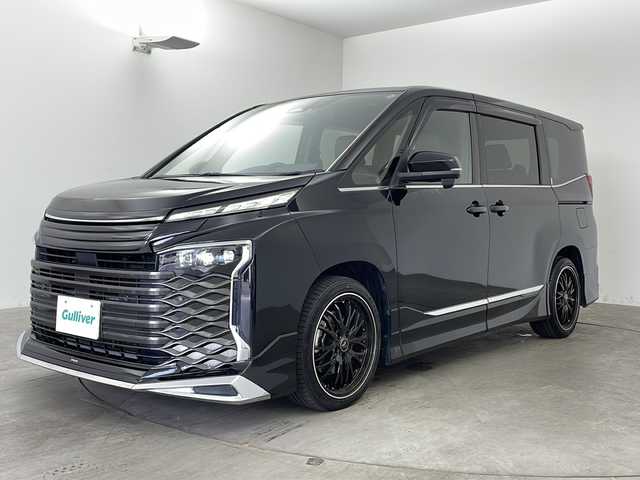 トヨタ ヴォクシー S－Z 兵庫県 2022(令4)年 4.6万km アティチュードブラックマイカ ・純正10．1インチディスプレイオーディオ/・フルセグ&BT&DVD&CD&Miracast/・純正13.2インチリアフリップダウンモニター/・モデリスタエアロ/・プロジェクター式3眼LEDライト/・デジタルインナーミラー/・社外18インチAW/・トヨタセーフティセンス/・レーンディパチャ―アラート/・プリクラッシュセーフティ/・クリアランスソナー/・パーキングサポートブレーキ/・ロードサインアシスト/・プロアクティブドライビングアシスト/・レーダークルーズコントロール/・オートマチックハイビーム/・両側パワースライドドア/・シートヒーター/・前後ドライブレコーダー/・ステアリングリモコン/・純正フロアマット/・スマートキー/・社外テールランプ