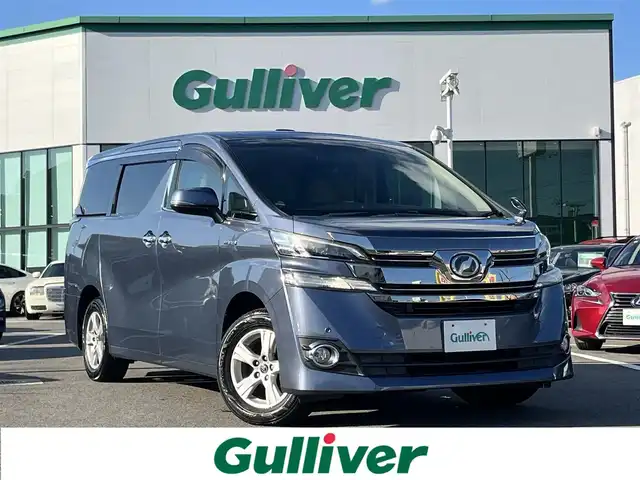 トヨタ ヴェルファイア ハイブリット X 愛媛県 2016(平28)年 6.4万km グレイッシュブルーマイカメタリック アルパイン製ナビ/BT/AM・FM/CD/DVD/フルセグTV/アルパイン製後席モニター/ビルトインETC/ドライブレコーダー/クルーズコントロール/パーキングアシスト/バックカメラ/両側パワースライドドア/8人乗り/オットマン/サンルーフ/純正アルミホイール/純正フロアマット