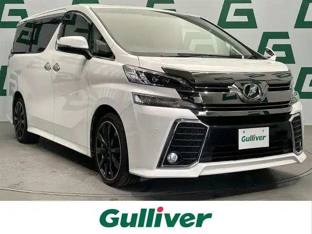 トヨタ ヴェルファイア Z 鹿児島県 2015(平27)年 6.5万km ホワイトパールクリスタルシャイン 禁煙車/純正9インチSDナビ(NSZT-Y64T)/　・Bluetooth/　・CD/DVD/　・フルセグTV/　・AM/FM/フリップダウンモニター/両側パワースライドドア/バックカメラ/ETC/電動パーキングブレーキ/ブレーキホールド/前後コーナーセンサー/後席オットマン/純正フロアマット/社外アルミホイール(huperion)/電動格納ミラー/ステアリングリモコン/全席オートパワーウィンドウ