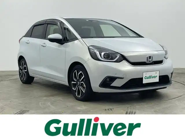 ホンダ フィット e:HEVホーム 岡山県 2020(令2)年 1.5万km プレミアムサンライトホワイトパール 純正９インチナビ/【Bluetooth/フルセグTV/USB】/純正16インチAW(オプション）/ハーフレザーシート/衝突軽減ブレーキ/追従型クルーズコントロール/ビルトインＥＴＣ/ＬＥＤヘッドライト＆LEDフォグランプ/オートハイビーム　/純正ドライブレコーダー（前後）/バックカメラ/純正フロアマット/踏み間違い防止/オートブレーキホールド/ISOFIX/ステアリングスイッチ/チルトステアリング/シートリフター/ウインカーミラー/ドアバイザー/プッシュスタート/スマートキー×2/保証書/取扱説明書/ナビ取扱説明書