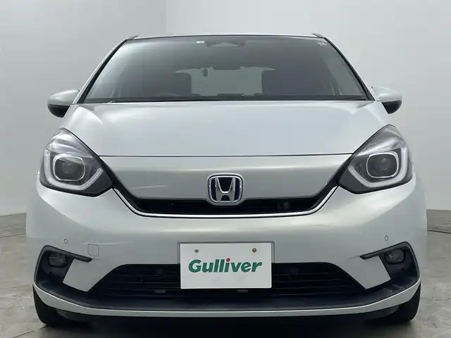 ホンダ フィット e:HEVホーム 岡山県 2020(令2)年 1.5万km プレミアムサンライトホワイトパール 純正９インチナビ/【Bluetooth/フルセグTV/USB】/純正16インチAW(オプション）/ハーフレザーシート/衝突軽減ブレーキ/追従型クルーズコントロール/ビルトインＥＴＣ/ＬＥＤヘッドライト＆LEDフォグランプ/オートハイビーム　/純正ドライブレコーダー（前後）/バックカメラ/純正フロアマット/踏み間違い防止/オートブレーキホールド/ISOFIX/ステアリングスイッチ/チルトステアリング/シートリフター/ウインカーミラー/ドアバイザー/プッシュスタート/スマートキー×2/保証書/取扱説明書/ナビ取扱説明書