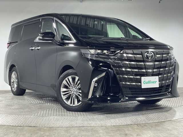 トヨタ アルファードハイブリット Z 神奈川県 2024(令6)年 0.7万km ブラック 純正14型ディスプレーオーディオプラス/ナビ/フルセグ 　/パノラミックビューカメラ/純正13.2型有機EL後席モニター【V13T-R72F】/ムーンルーフ/パワーサンシェード/両側電動スライドドア/デジタルインナーミラー/セーフティセンス/トヨタチームメイト/ブラインドスポットモニター/プリクラッシュセーフティ/レーントレーシングアシスト/レーンディパーチャーアラート/レーダークルーズコントロール/アダブティブハイビームシステム/ロードサインアシスト/ドライバー異常対応システム/プロアクティブドライビングアシスト/発進遅れ告知機能/アドバンスパーク/パーキングサポートブレーキ/アドバンストドライブ/レーンチェンジアシスト/前後ソナー/パワーバックドア/パドルシフト/ステアリングヒーター/合皮シート/前席パワーシート/ベンチレーション/運転席ポジションメモリー/置くだけ充電/AC100V/2列目エグセクティブパワーシート/ETC2.0/社外前方ドライブレコーダー/3眼LEDヘッドライト/純正18インチアルミホイール