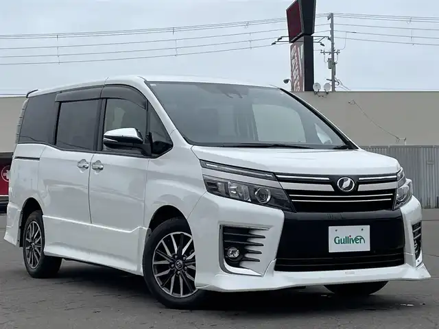 トヨタ ヴォクシー ZS 煌Ⅱ 道東・釧路十勝 2016(平28)年 5.5万km ホワイトパールクリスタルシャイン 4WD/ワンオーナー/寒冷地仕様車/Toyota Ssrty Sense C/・PCS(プリクラッシュセーフティシステム)/・LDA(レーンディパーチャーアラート)/・オートマチックハイビーム/・先行車発進告知機能/TRDフルエアロ/ (フロント/サイド/リア/リアアンダー)/社外メモリナビ/ (CD/DVD/BT)/フルセグTV/バックカメラ/ビルトインETC/社外ドライブレコーダー/両側パワースライドドア/革巻きステアリング/ステアリングスイッチ/クルーズコントロール/プッシュスタート/スマートキー/スペアキー/純正16インチAW/社外16インチAW付スタッドレスタイヤ積込/オートライト/純正LEDヘッドライト/フォグランプ/ウインカーミラー/電動格納ミラー/純正ドアバイザー/純正フロアマット/アイドリングストップ/横滑り防止装置/ナビ取扱説明書/取扱説明書/保証書