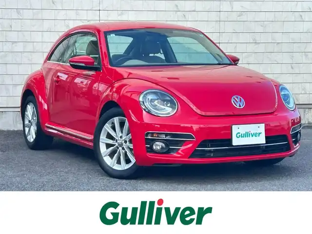 フォルクスワーゲン ザ・ビートル デザイン 大分県 2019(平31)年 8.1万km 赤 Volkswagen 純正ナビゲーションシステム/“716SDCW”【OP】/【Bluetooth/フルセグTV/DVD/CD/SD】/本革シート/前席シートヒーター/社外前後ドライブレコーダー/外部端子接続：USB/バックカメラ/スタティックコーナリングライト/ブラインドスポットディクション/ドライバー疲労検知システム/リアトラフィックアラート/ECS/ABS/ブレーキアシスト/バイセンキセノンヘッドライト【OP】/プッシュスタート/スマートキー2本/保証書/取扱説明書