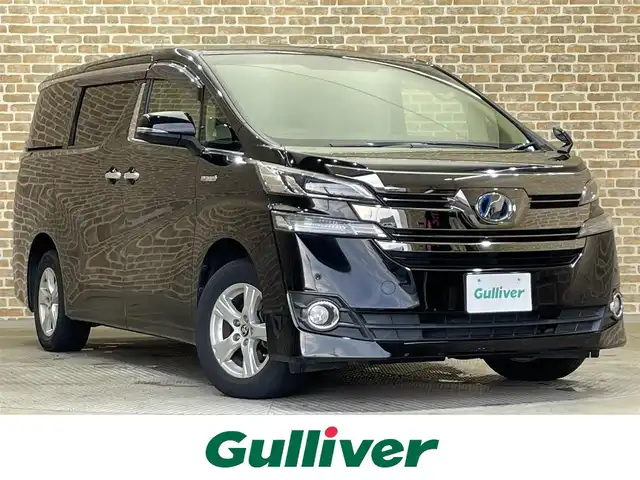トヨタ ヴェルファイア ハイブリット X 岩手県 2015(平27)年 11.5万km ブラック ４WD/寒冷地仕様/ツインムーンルーフ/ALPINE12.8インチ後席ディスプレイ/ALPINE10インチナビゲーション/両側パワースライドドア/クルーズコントロール/クリアランスソナー/横滑り防止装置/MTモード付AT/オートブレーキホールド/AC100V1500Wアクセサリーコンセント/Clazzioレザー調シートカバー/２列目シートオットマン/リヤオートエアコン/バックカメラ/ETC/エンジンスターター/フルセグTV/LEDヘッドライト/フロント・リヤフォグランプ/ワイパーデアイサー/純正16インチアルミホイール