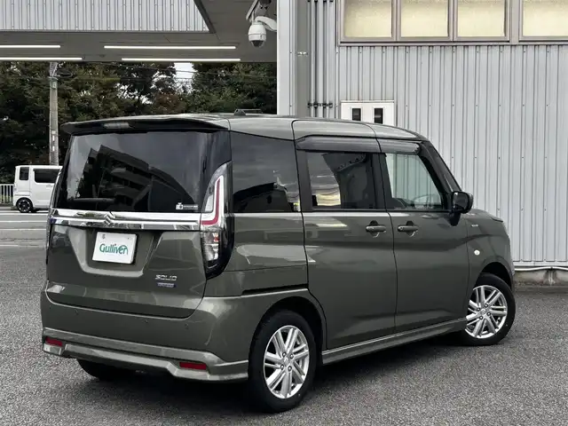 スズキ ソリオ HV MX 静岡県 2024(令6)年 0.7万km タフカーキパールメタリック ユーザー買取車両/ワンオーナー/純正ナビ/　【CD/DVD/BT/地デジフルセグTV】/純正LEDヘッドライト/純正15インチAW/衝突被害軽減システム/車線逸脱警報/レーダークルーズコントロール/全方位カメラ/ビルトインETC/前席シートヒーター/ドライブレコーダー/片側パワースライドドア/USBポート/新車時保証書/取扱説明書/スペアキー×1